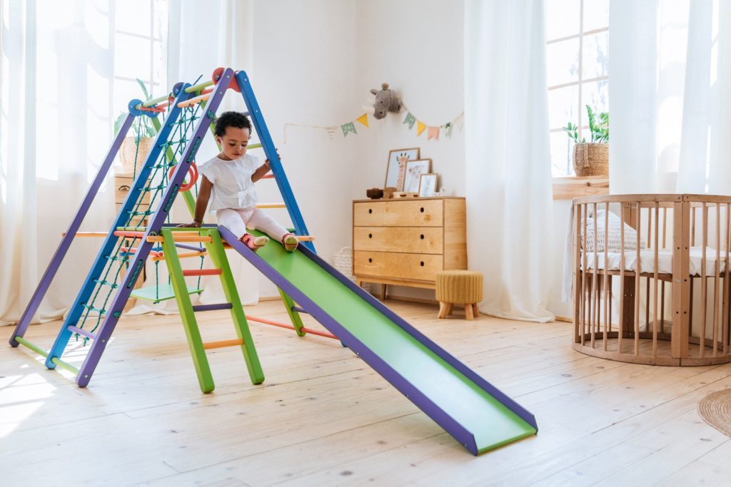 A toddler going down the slide on the Panda Playground