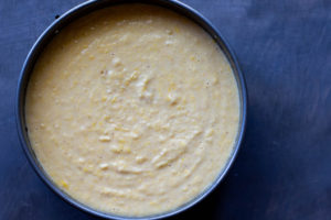 Cake batter for the almond orange cake in an 8 inch cake pan