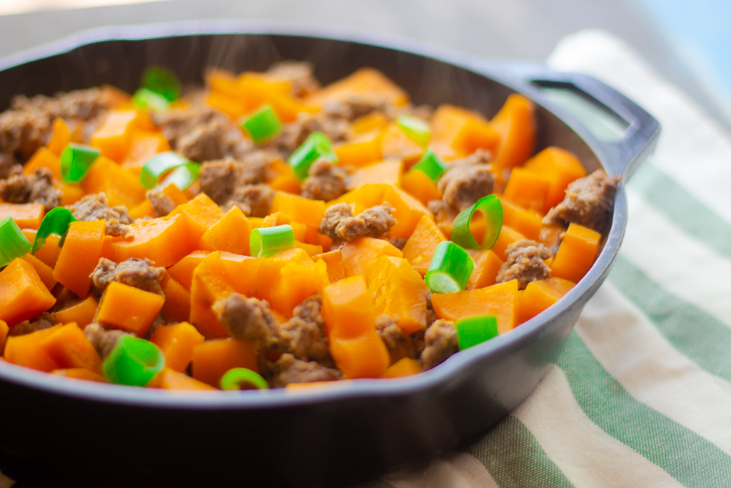 Paleo ground beef and sweet potato meal in an iron skillet steaming