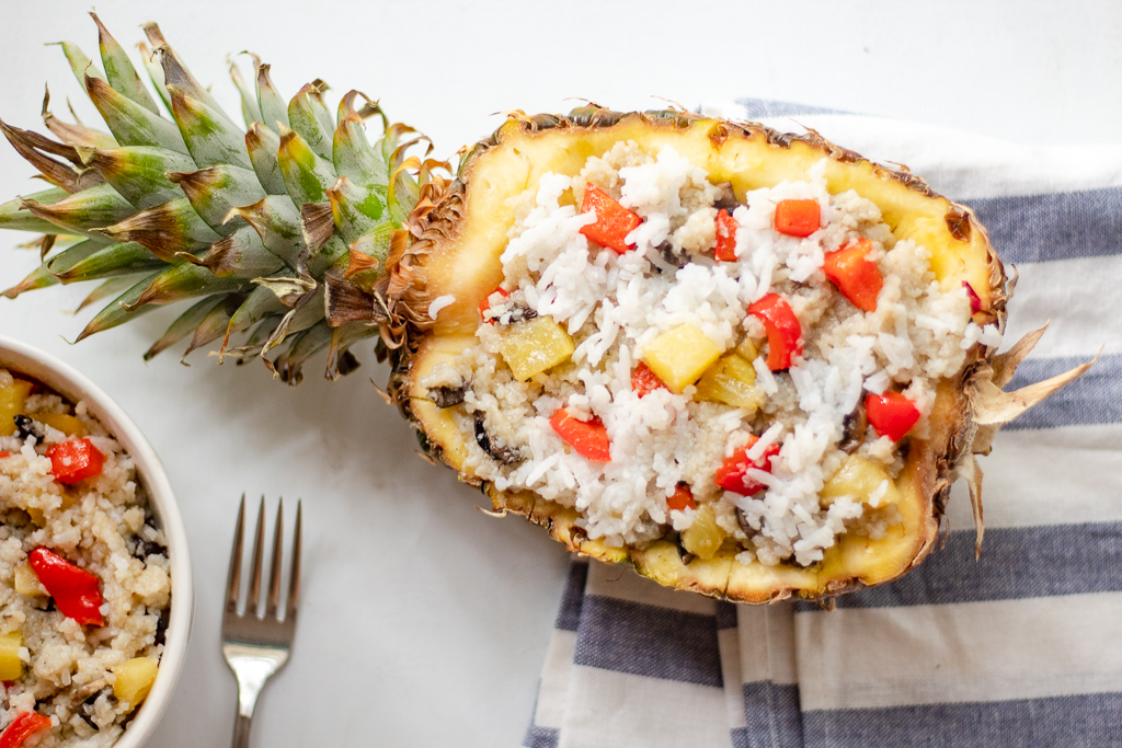A half of pineapple stuffed with fried rice