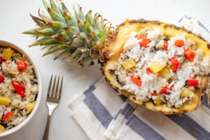 A half of pineapple stuffed with fried rice