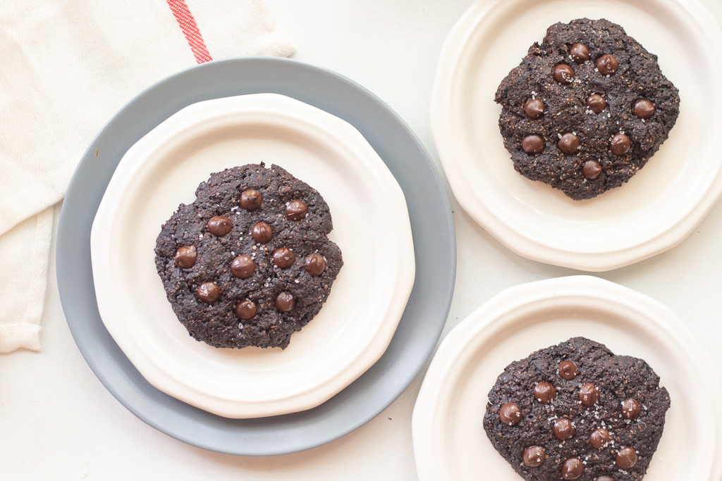 three Vegan Chocolate Cookies one on each plate