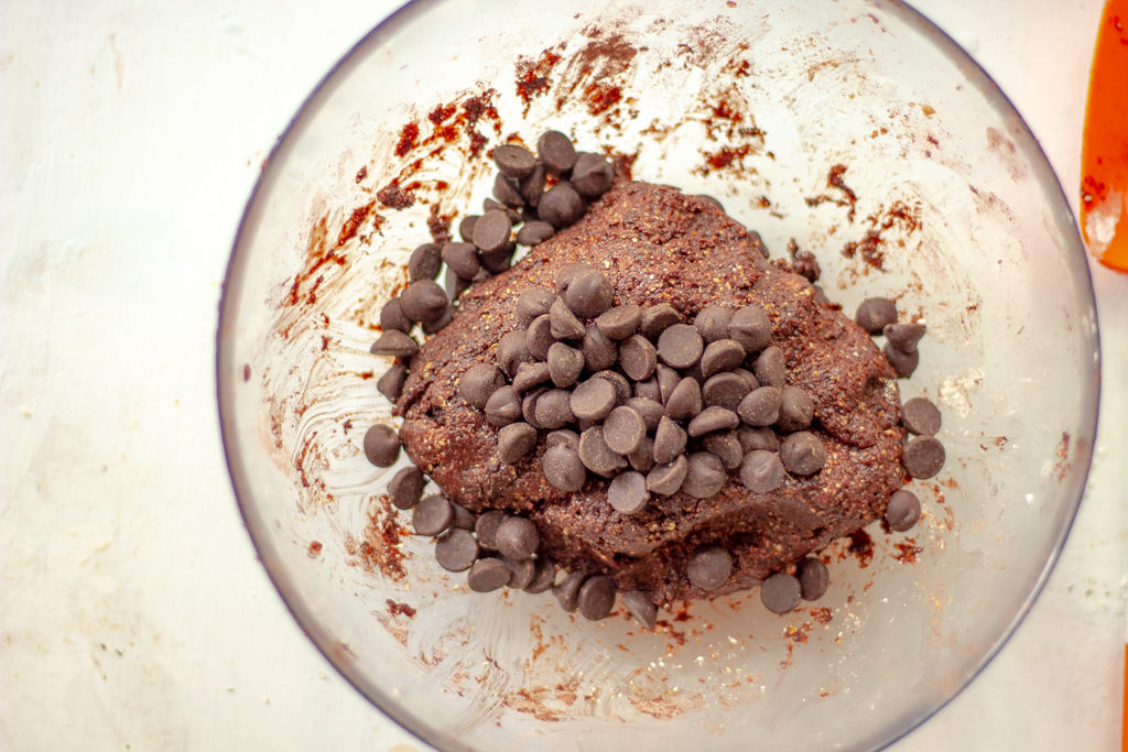 A bowl with chocolate cookie dough and added chocolate chips to the top