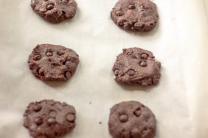 unbaked cookies on a baking sheet lined with parchment paper