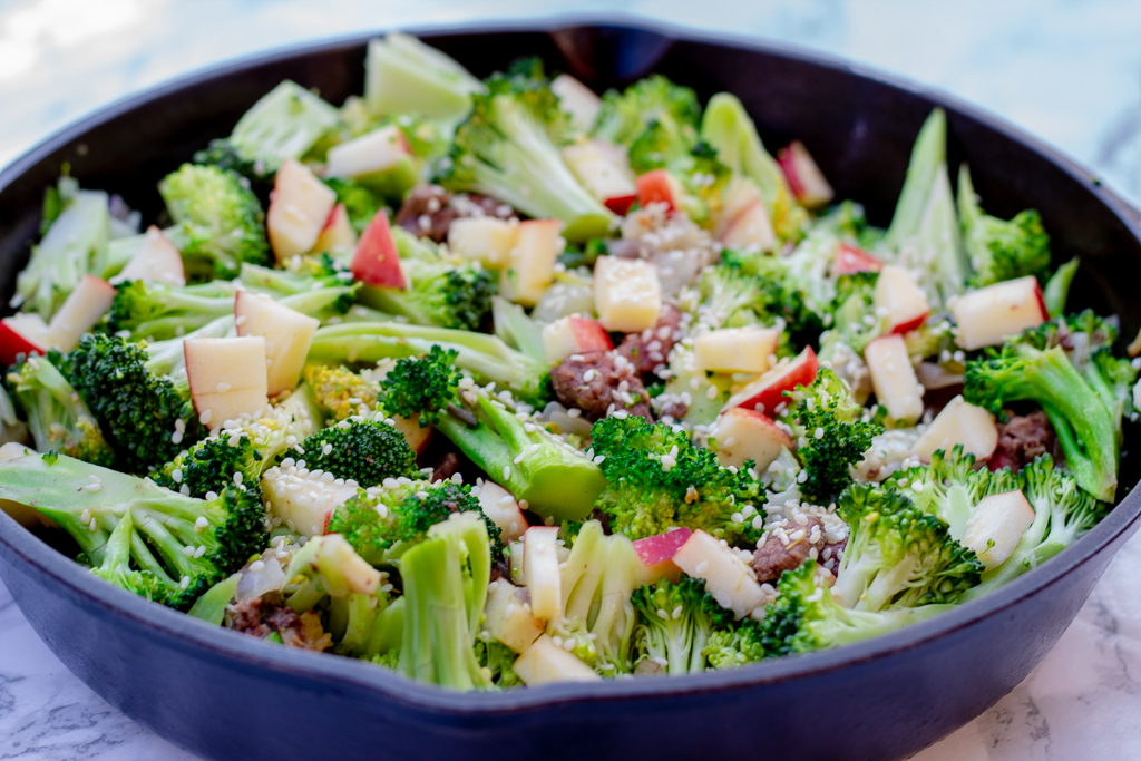 Skillet with beef and broccoli and apples and sesame seeds