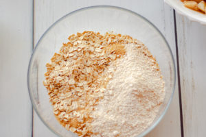 A bowl with oats,sugar, and oat flour for the topping of the apple crisp
