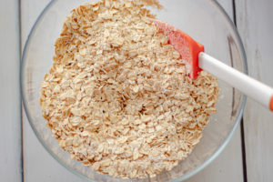 A bowl with oats,sugar, and oat flour for the topping of the apple crisp