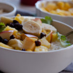a bowl with split pea coconut curry with fruit topping