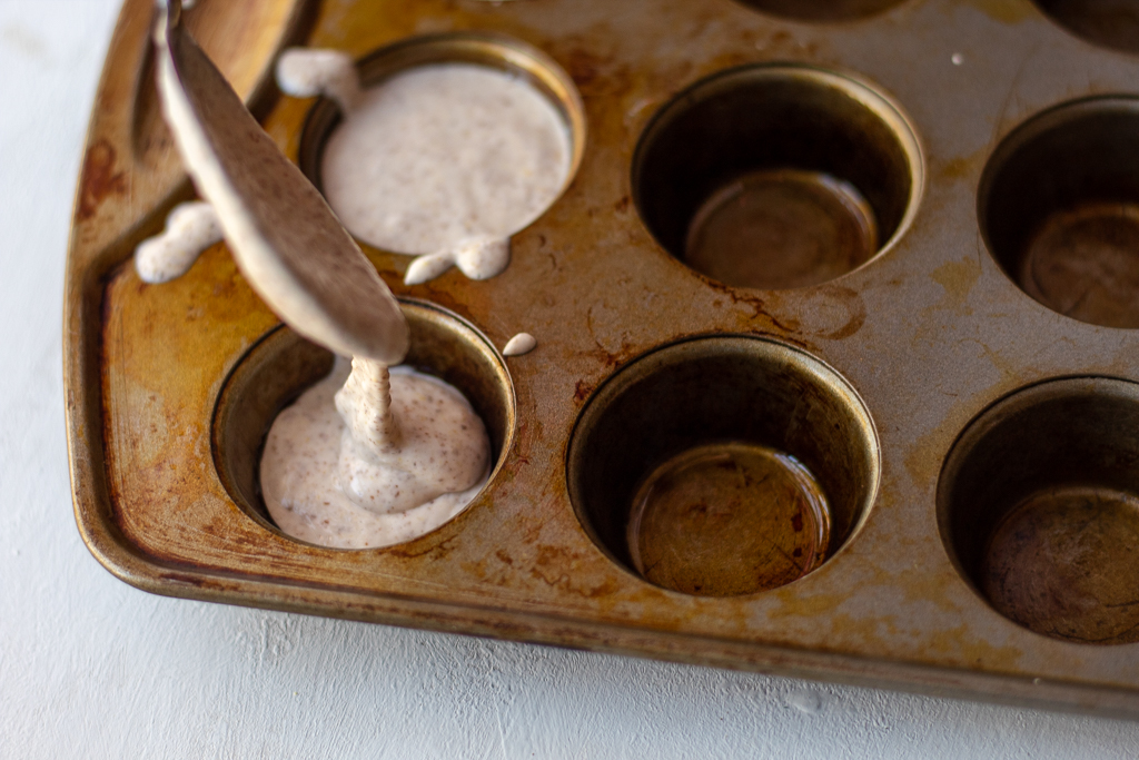 adding the rolls' dough to the muffin pan