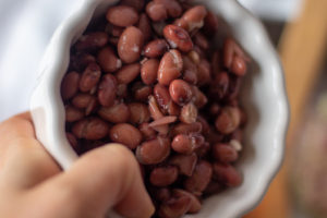adding beans to the vegan chili