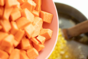 adding sweet potatoes to the vegan chili