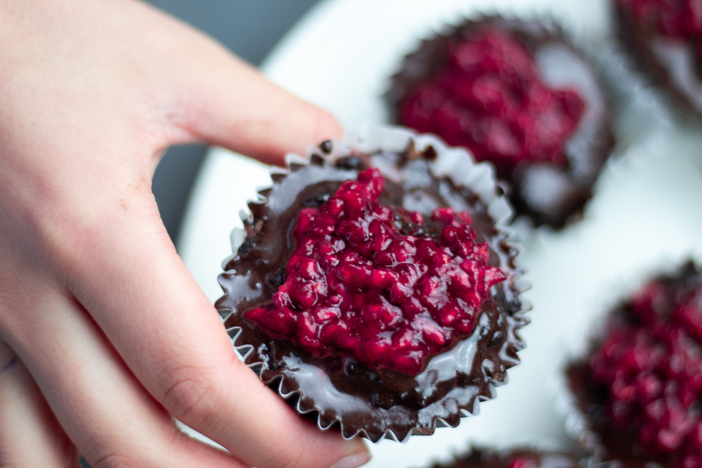 someone holding a Chocolate Blueberry Paleo Cupcake