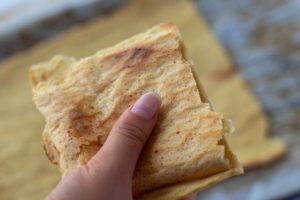 someone holding gluten-free flatbread