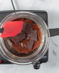 Chocolate bars in a glass bowl over a pot of water on the stove