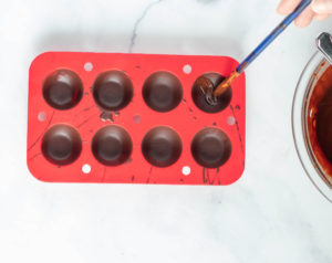 adding a second layer of chocolate to the silicone mold