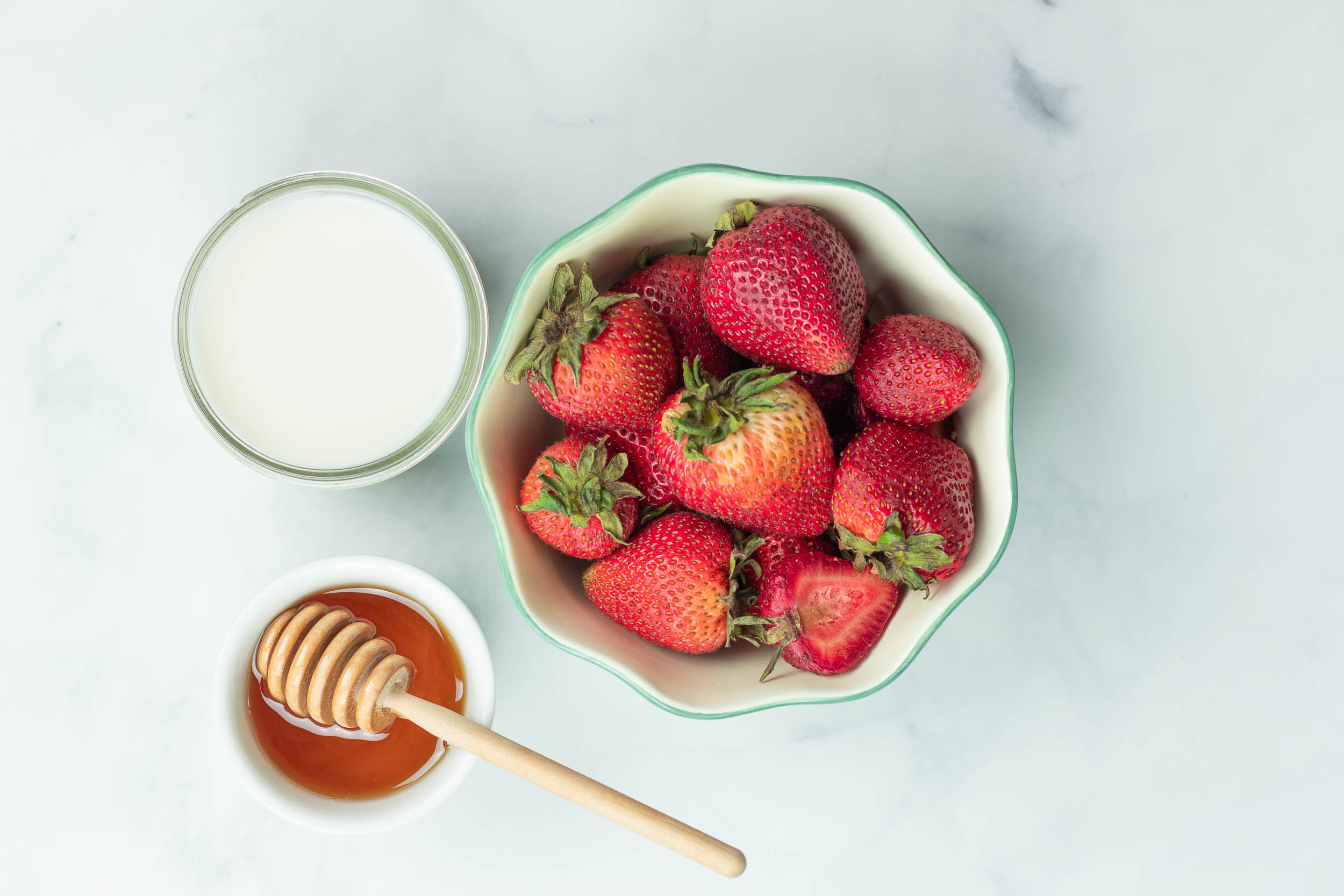 Ingredients for strawberry smoothie. Strawberries, honey, plant-based milk