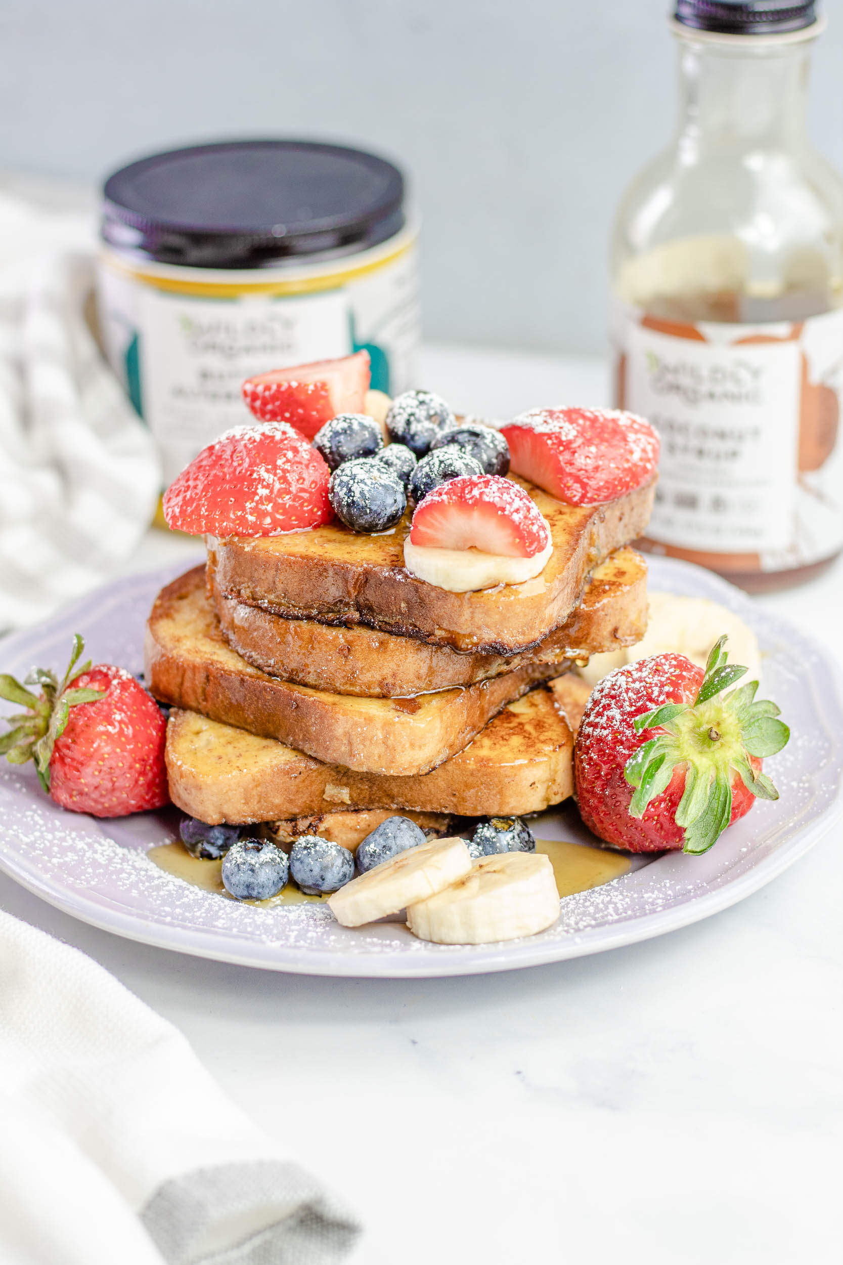 French toast on a plate covered with fresh fruit