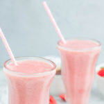 Strawberry smoothie in two glasses with straws